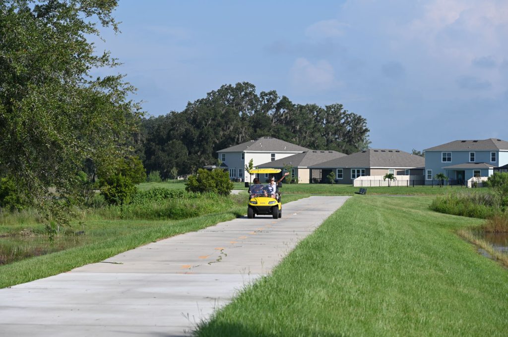 Connected City Trail with Woman Waving in Golf Cart
